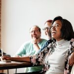 A team of employees smiling and laughing during a casual business meeting